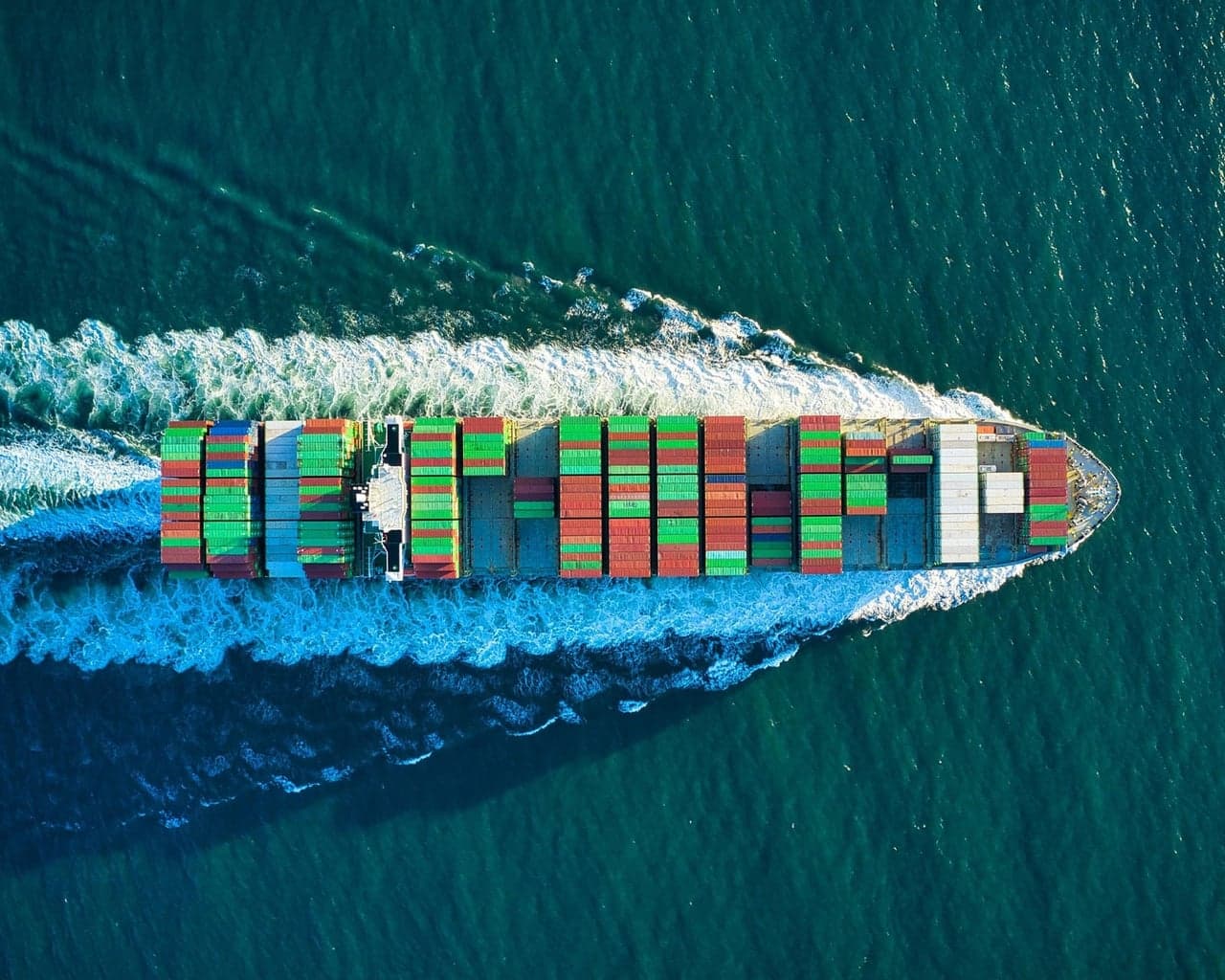 Container ship loaded with export containers sailing across the sea